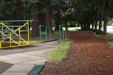 On-street parking at east end of park off NE 244th – curb cut leads to paved  walkway and ramp to baseball field